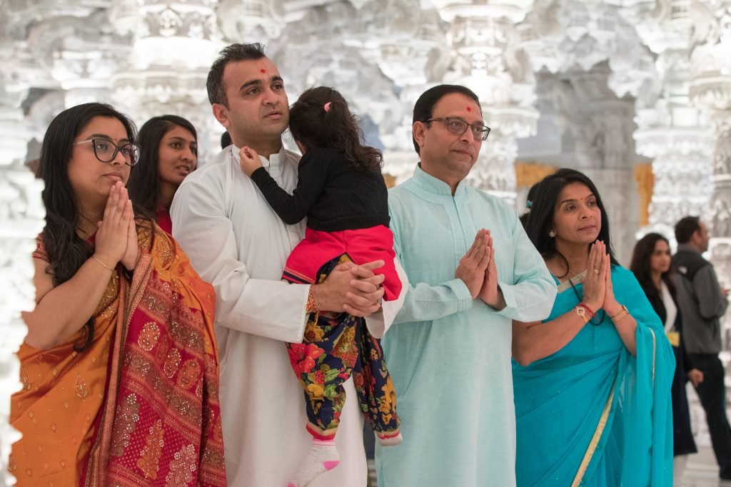 Adults and children outside temple