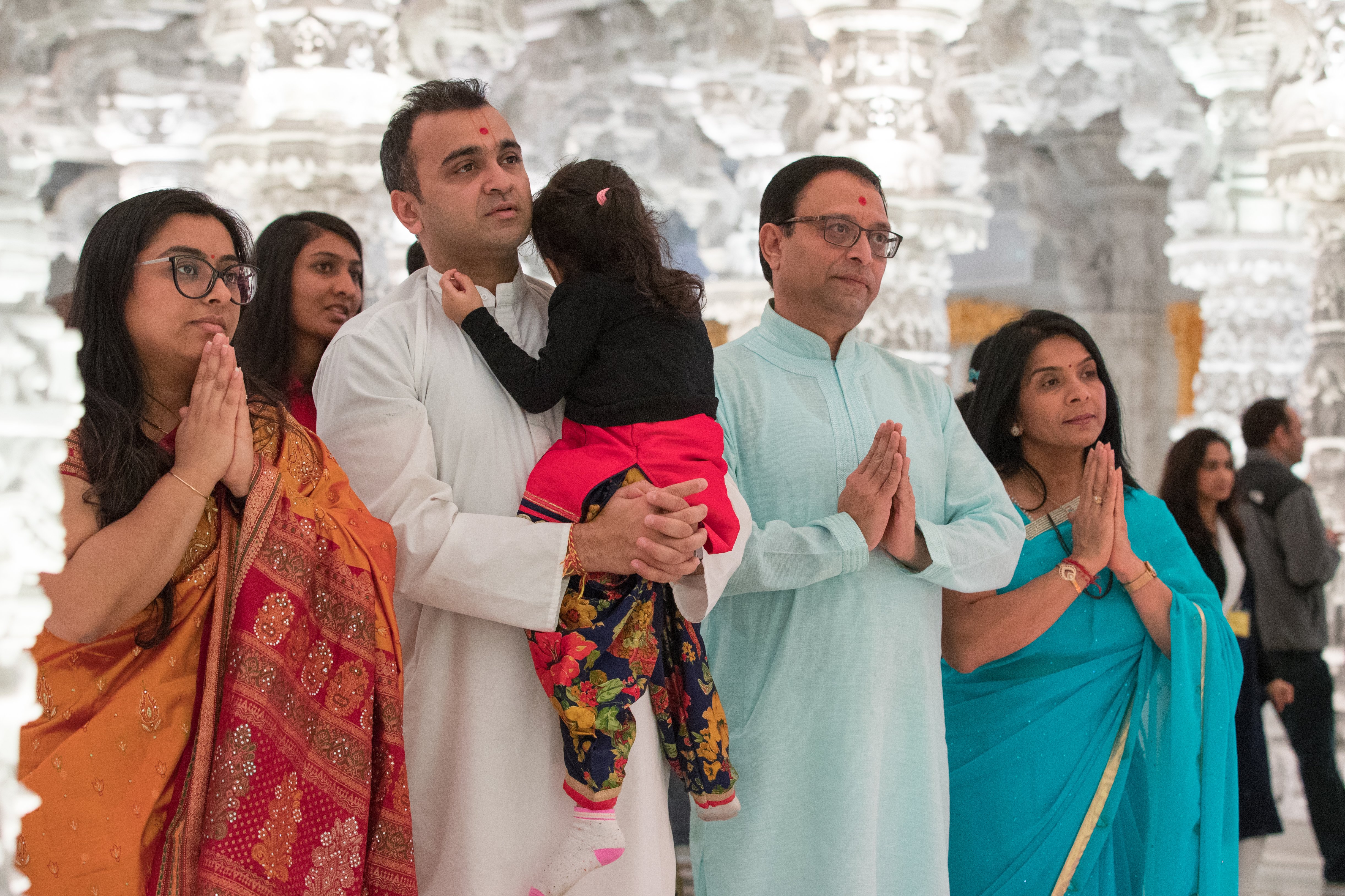 Adults and children outside temple